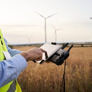 Operator holding remote control operating drone using remote controller Engineer playing with drone